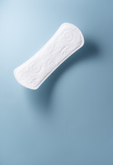 close up view of woman's sanitary pad on color back