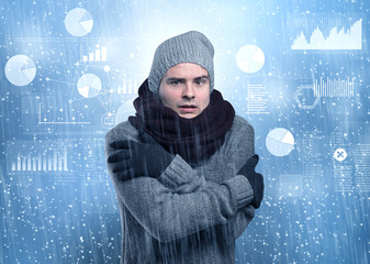 Young businessman shivering with graphs, reports and chart concept
