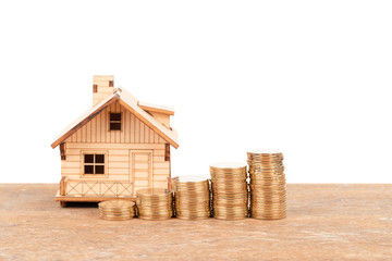 Model house and coin stack on white background mortgage saving concept