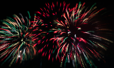 Fototapeta premium Abstract Colorful Red and White and Green Fireworks with Black Sky Background