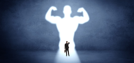 Businessman standing and dreaming about a strong superhero
