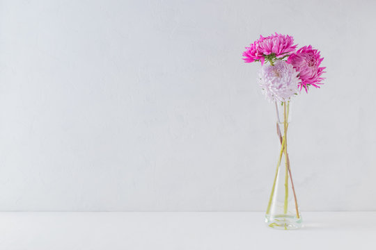 Pink Flowers In A Vase On A Light Background