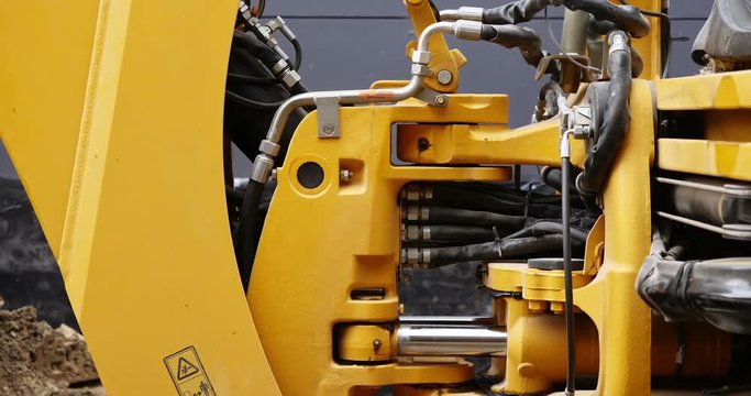 Modern excavator is working on a big construction site