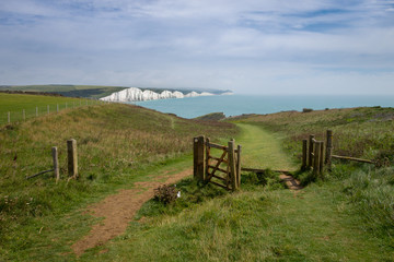 Looking towards Cuckmere Haven on the Vanguard Way public footpath with Birling Gap and the Seven Sisters in the distance.