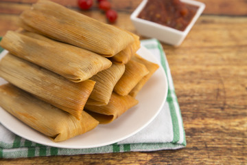 Plate Filled with Homemade Tamales Ready for Dinner on a Wooden Table
