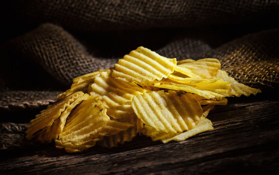 Potato chips on rustic wooden table