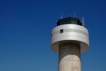 Tower of an airbase in front of a clear blue sky