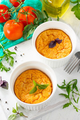 Vegetarian vitamin breakfast French baked cheese souffle with tomato  on a wooden table. Vegan dish. Proper nutrition. Healthy lifestyle.