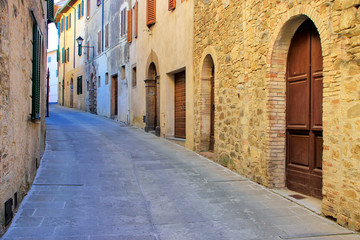 Fototapeta na wymiar Narrow street in historic center of Montalcino town, Val d'Orcia, Tuscany, Italy