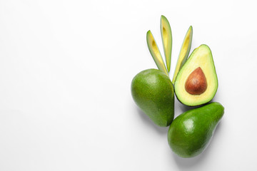 Composition with ripe fresh avocados on white background