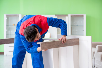 Repair contractor repairing broken furniture at home