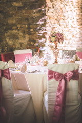 wedding table with exclusive floral arrangement prepared for reception, wedding or event centerpiece in rose gold colour