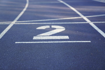 Number 2 start position of an outdoor stadium running track with white dividing lines