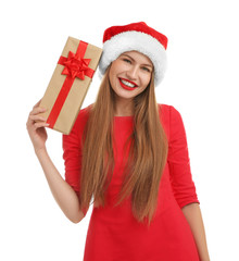 Young beautiful woman in Santa hat with gift box on white background. Christmas celebration