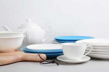 Set of dishware on table against white background