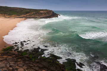 Beautiful landscape of  rugged coastline with waves crashing against the cliffs. View of seascape coast and  Atlantic ocean waves in a north winds days in Portugal.
