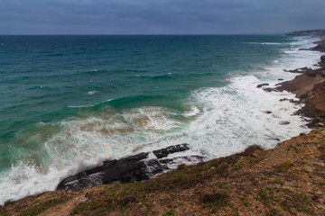 Beautiful landscape of  rugged coastline with waves crashing against the cliffs. View of seascape coast and  Atlantic ocean waves in a north winds days in Portugal.