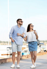 Fototapeta na wymiar Young hipster couple in jean clothes on pier