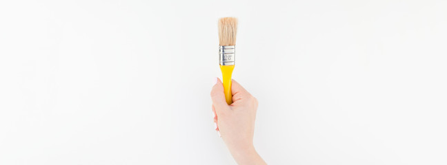 Woman hand holding new paint brush isolated