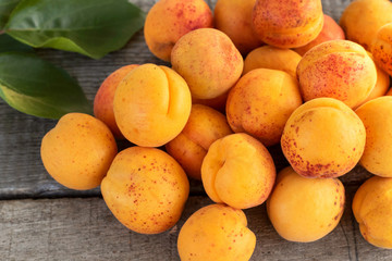 Delicious ripe apricots on wooden table, rustic.