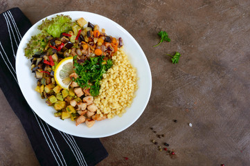 Delicious oriental salad tabbouleh. Couscous with fried vegetables and chicken on a white plate. Traditional Lebanese appetizer.