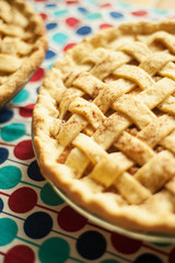 Two apple pies on a tea towel