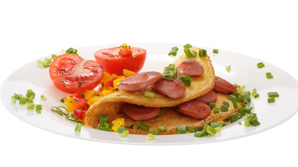 Omelet with sausages and tomatoes on a plate is decorated with onions. Isolated on white background.