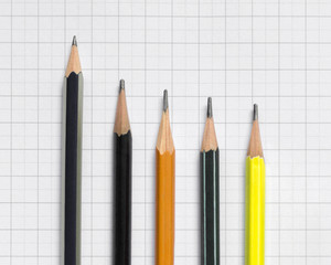 Pencils lie on a sheet of paper