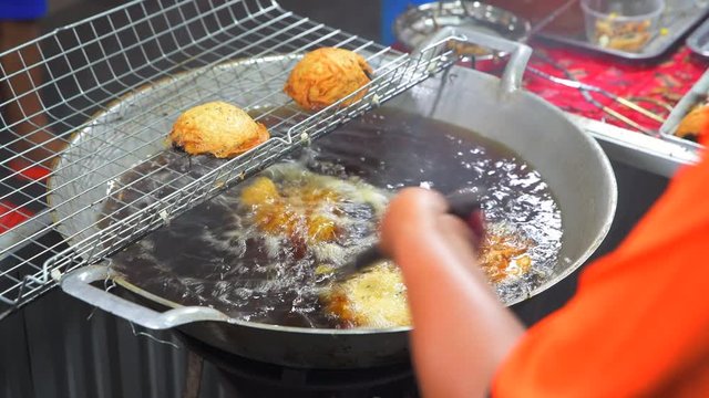 4K Closeup shot of Frying meatballs in Chinees Walking Street, Street Foods, Bangkok, Thailand