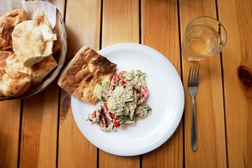 Georgian traditional salad with cucumber, tomatoes and coriander