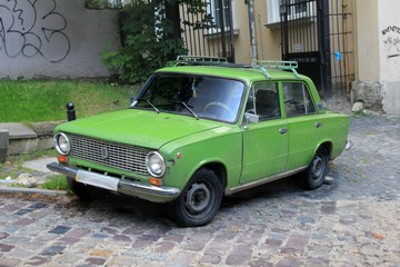 The old green car on the street