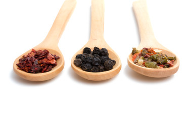 wooden spoon filled with various spices isolated on the white