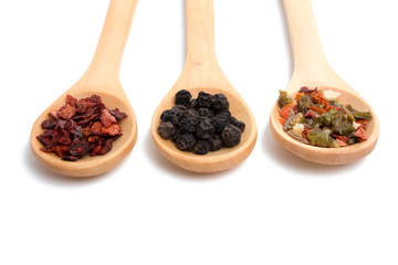wooden spoon filled with various spices isolated on the white
