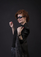 Emotional brunette posing in the Studio in a leather cloak.