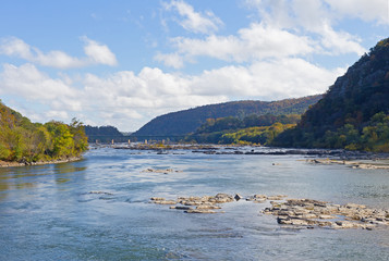 Bridge over Shenandoah River in Harpers Ferry, West Virginia, USA. Blue Ridge Mountain in Harpers Ferry National Historical Park in autumn.
