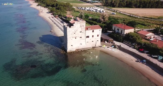 Torre Mozza, Piombino, Toscana, Italy  16 June 2018. Aerial view on the sea, beach and ancient fortress at morning light