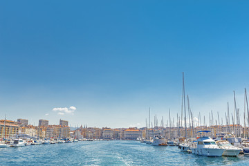 Marseille, France, breathtaking seascape and port. View from sea. Port Marseille, yachts in marina and cityscape on background. Plenty of copy space as blue sky background for advertisement script. 