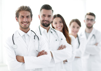 Fototapeta premium Portrait of medical team standing with arms crossed in hospital