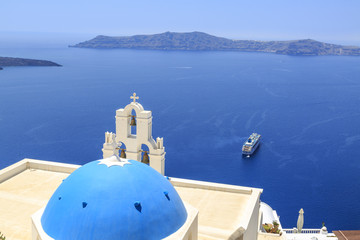 Fototapeta na wymiar Three bells of Fira Church in Fira, Santorini island, Greece with cruise ship on sea