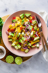 grilled corn , avocado salad with blue onion and chili pepper. healthy summer breakfast or lunch