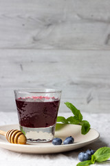 Healthy detox drink with blueberries, honey and mint.
