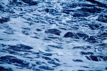 Blue sea with waves and foam background