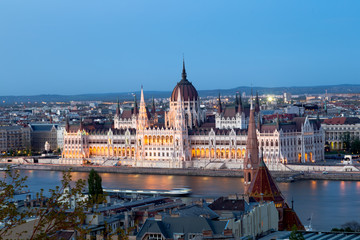 Sunset in Budapest. View of hungarian parliament, the most beautiful building in Europe in neo-gothic style. 