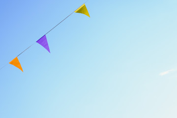 Colorful pennants with sky background to place text