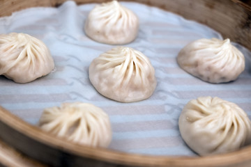 China steamed bun or xiaolongbao in small bamboo basket.