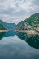 Fototapeta premium The picturesque turquoise lake is among the high mountains.