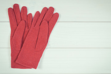 Womanly gloves on white boards, clothing for autumn or winter, copy space for text or inscription