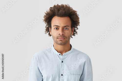 Serious Self Assured Mixed Race Male With Curly Hair Looks