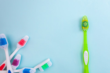 Toothbrushes on light blue background, close up different kinds of Toothbrushes, new not used, isolated for text insertion, one of the best, old and new brushes