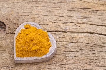 turmeric in bowl on table, top view